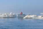 Boating in the fog among dangerous ice floes